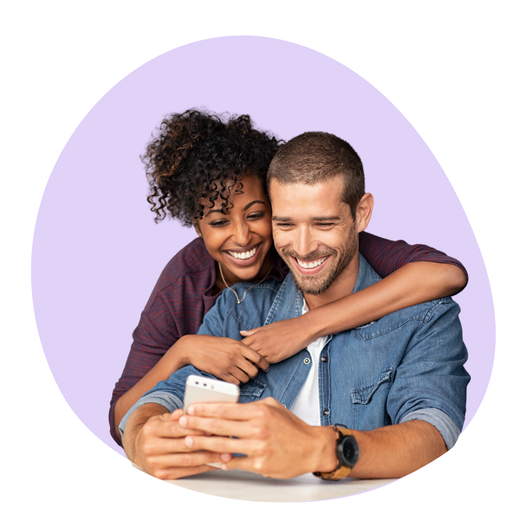 couple looking at phone, smiling